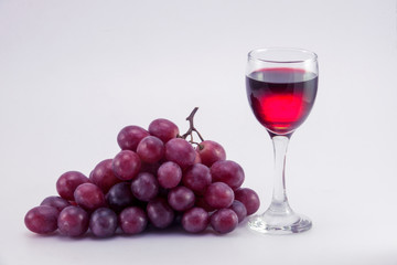 glass of wine and grapes, isolated on white