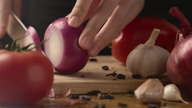 Female hands cutting onion whith knife