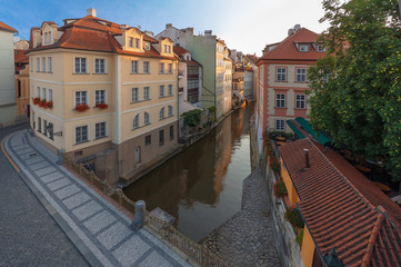Fototapeta na wymiar Kampa, the part of Prague situated in Lesser Town and Devil´s stream (Certovka), the view taken from Charles bridge during the sunrise.
