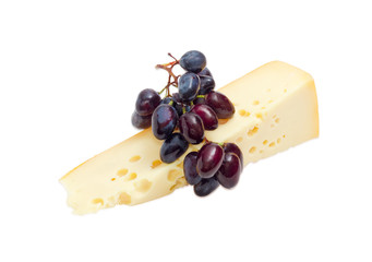 Piece of Swiss-type cheese and blue table grapes