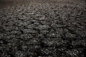 Crack asphalt closeup textured background.