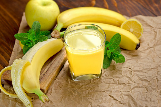 Banana smoothie (juice) and banana on table - healthy drink (healthy beverage)