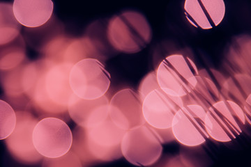 Bokeh dark pink circles and shade grasses on black background. Abstract  festive background.