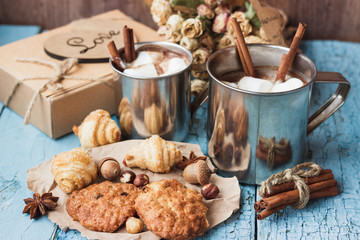 Metal mugs with cacao and marshmallows