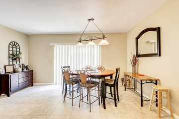 Bright and light dining room with bar style chairs and tile floor