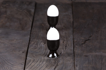 black cup of egg, egg white, black wooden table