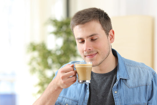 Man tasting coffee at home