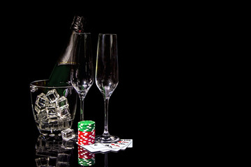 Bottle champagne in ice bucket with two wineglasses