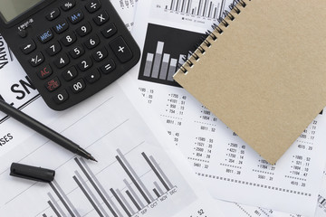 financial accounting stock market graphs analysis with white table. over light 