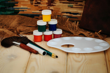 Colorful paints brushes and palette