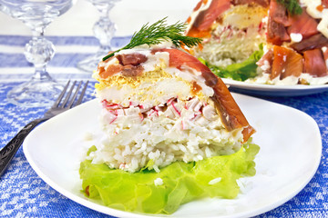 Salad with salmon and rice in plate on tablecloth