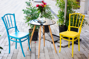 Yellow and blue retro chairs.Street cafe