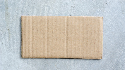 cardboard paper on the gray concrete for the background.