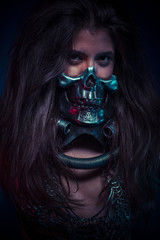 Halloween party, brunette girl with metallic skull mask
