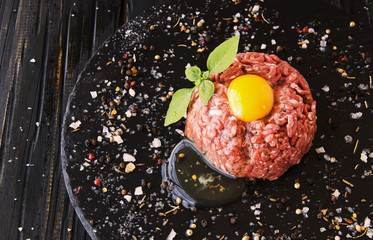raw minced meat, vegetables with salt and spices, selective focus