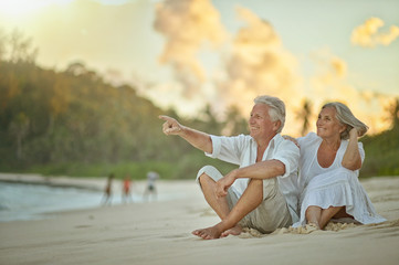 elderly couple rest at tropical beach