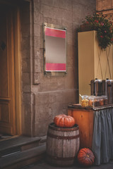 Street cafe with halloween decorations - pumpkins on barrel. Focus on pumpkin