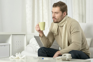 sick man  drinking warm  tea