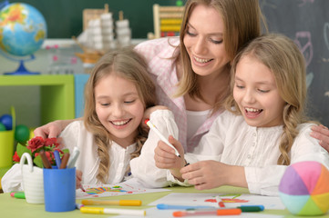 girls  with mother on lesson of art