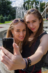 girlfriends are making selfie on the street