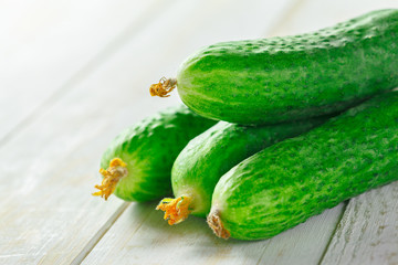  cucumbers on wooden background