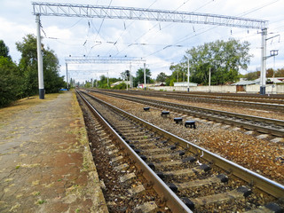 Railroad track under blue sky on summer