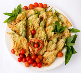 Young zucchini flowers deep fried with cheese, tomato and basil.