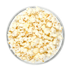 Popped popcorn in glass bowl on white background. Butterfly shaped popcorn puffed up from the kernels, after it has been heated. Edible and vegan food. Isolated macro photo close up from above.
