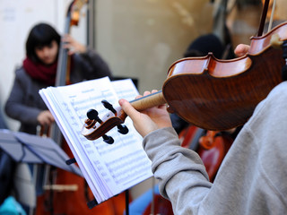 Music Day, young musicians playing stringed instruments on the street
