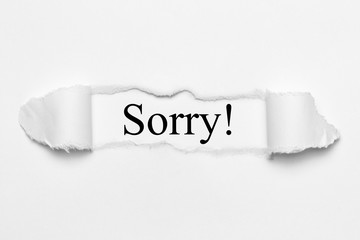 Sorry! on white torn paper