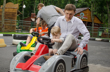 Small baby boy is enjoying driving small car