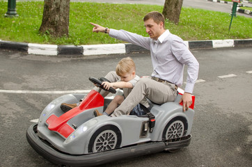 Small baby boy is enjoying driving small car