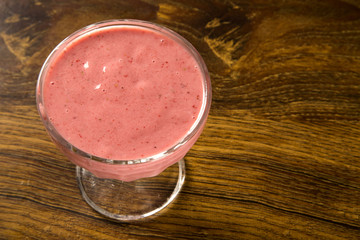 bowl of strawberry pudding isolated on wooden background