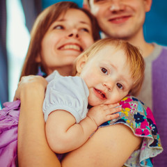 Tender little girl leans to mother's shoulder