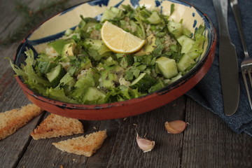 vegan healthy salad with bulgur, cucumber, avocado and crispy toast