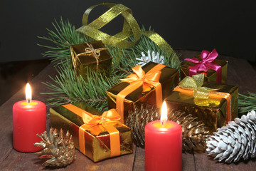 Christmas Composition with glass cognac, Gift box and candle on wooden table