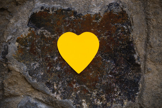 yellow heart shaped mock up frame on stylish vintage stone background