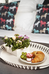 french breakfast presented with flowers on a bed
