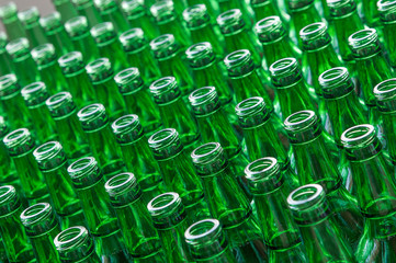 a large number of transparent glass bottles of green color closeup