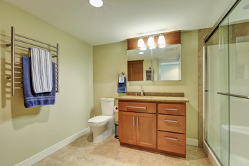 Fototapeta na wymiar Interior of beige bathroom with modern vanity cabinet