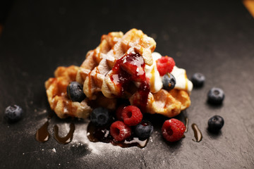 Fresh homemade waffles with ricotta served with whipped cream and berries