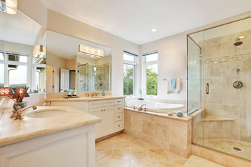 Master bathroom interior with beige tile floor