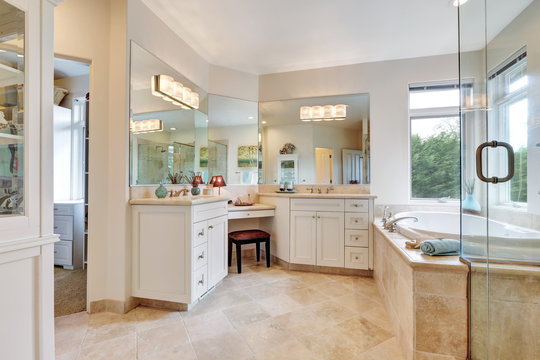 Master bathroom interior with beige tile floor