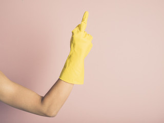 Hand in rubber glove showing middle finger