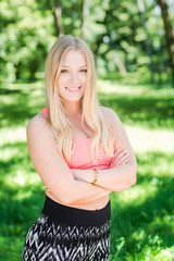 Fototapeta premium Healthy and beautiful young woman in sports bra jogging in the park