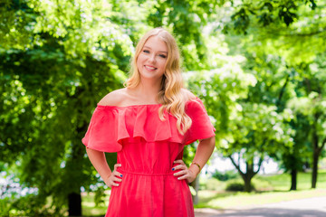 Fototapeta premium Young smiling blonde woman outdoors portrait. Soft sunny colors.Close portrait.