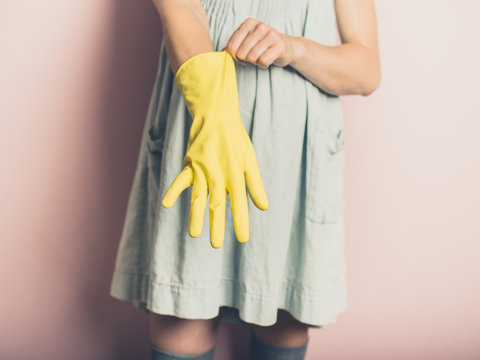Woman putting on rubber glove