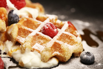 Fresh homemade waffles with ricotta served with whipped cream and berries