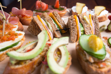 Bruschetta crostini set on a wooden tray. The concept of the Italian cuisine.