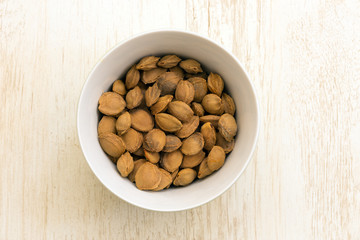 apricot seeds in a white plate..